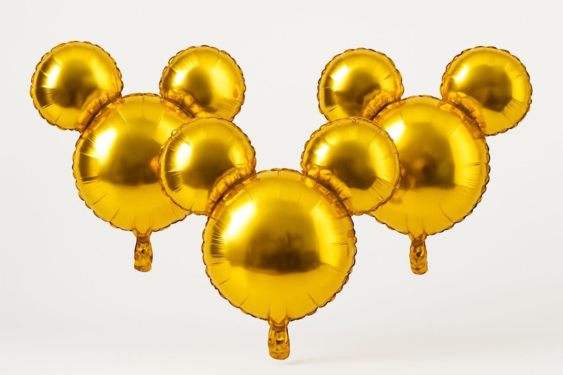 Puede incluir: Varios globos dorados con forma de cabeza de rat&oacute;n. Los globos son redondos y tienen un acabado met&aacute;lico brillante. Estos globos inflados son adecuados para una fiesta o celebraci&oacute;n.