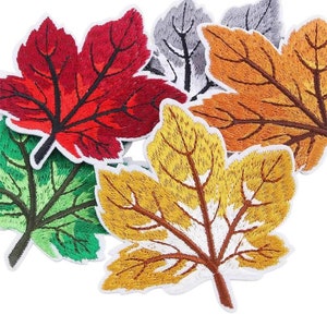 May include: Five embroidered felt maple leaf patches in various colors, including red, green, orange, yellow, and gray.