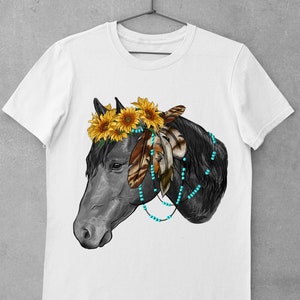 May include: A white t-shirt with a black horse head illustration. The horse is wearing a sunflower crown and turquoise beads with feathers.