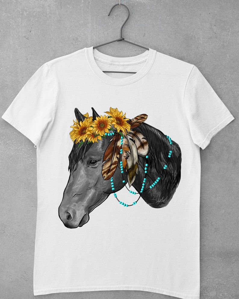 May include: A white t-shirt with a black horse head illustration. The horse is wearing a sunflower crown and turquoise beads with feathers.