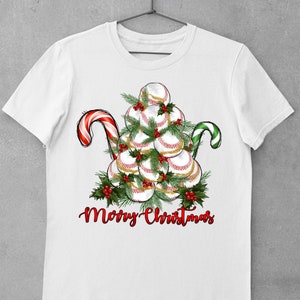 May include: White t-shirt with a Christmas tree made of baseballs, red and green candy canes, and the text "Merry Christmas".