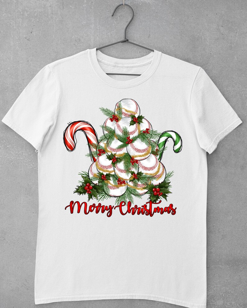 May include: White t-shirt with a Christmas tree made of baseballs, red and green candy canes, and the text "Merry Christmas".