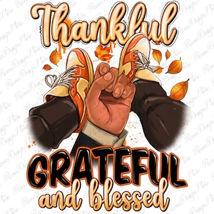 May include: A Thanksgiving-themed graphic design featuring a pair of brown shoes with orange and white accents, a hand reaching up, and the text "Thankful, Grateful and Blessed" in orange and black lettering.