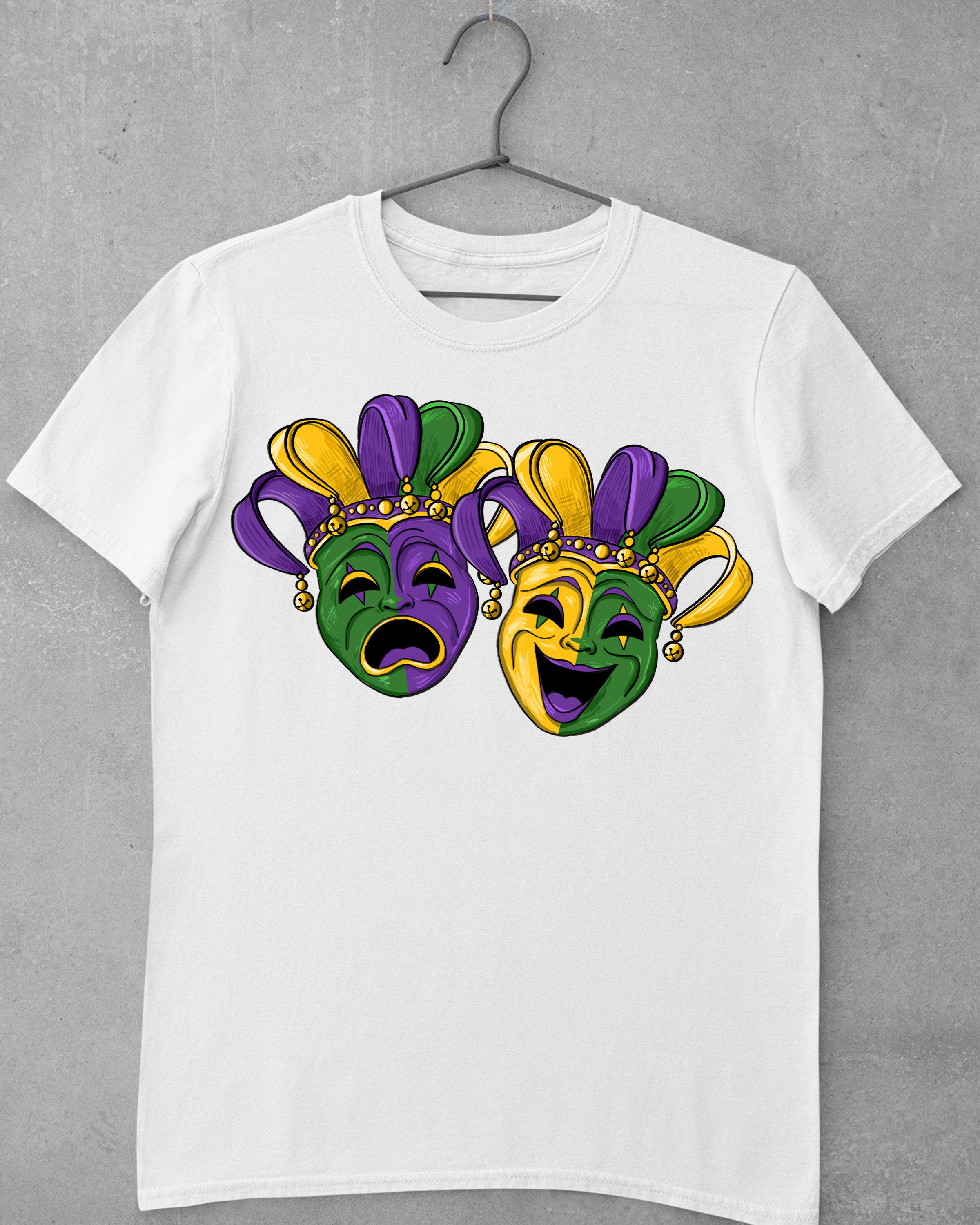 May include: White t-shirt with a purple, green, and gold design of two Mardi Gras masks. One mask is crying and the other is laughing.