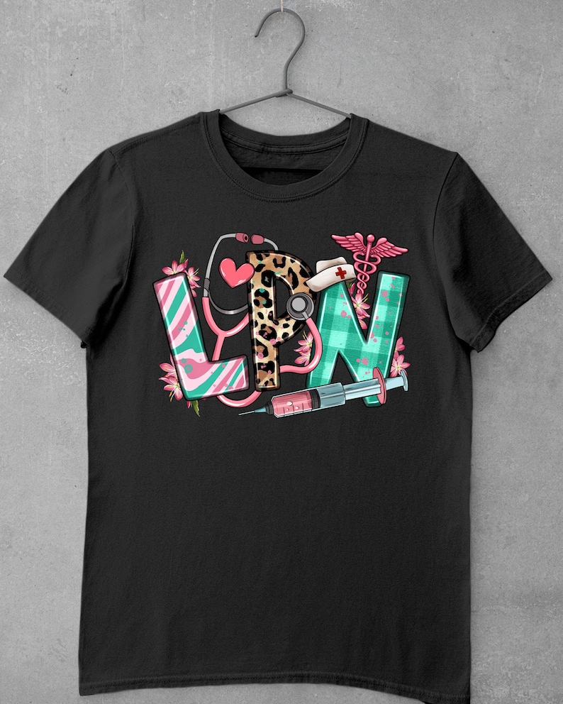 May include: Black t-shirt with a graphic of the letters LPN in different colors and patterns. The letters are decorated with medical symbols, including a stethoscope, a syringe, and a caduceus.