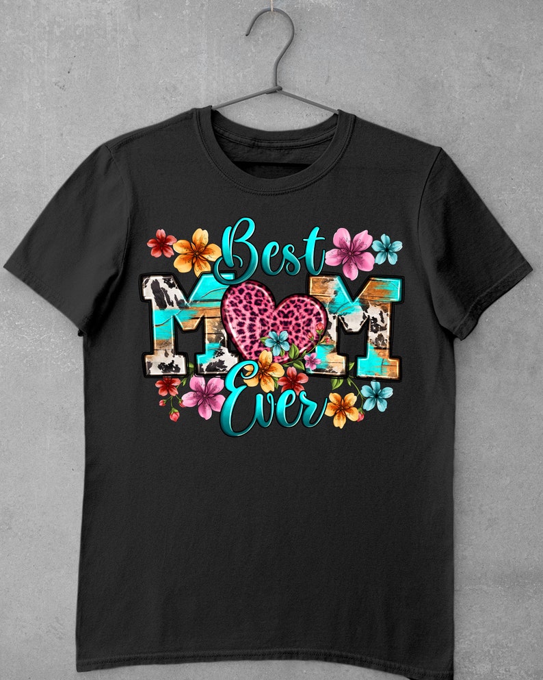 May include: Black t-shirt with a colorful graphic design that says "Best Mom Ever". The graphic features a heart with a leopard print, flowers, and a turquoise background.