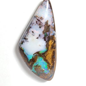May include: A white, brown, and blue opal gemstone with a teardrop shape.