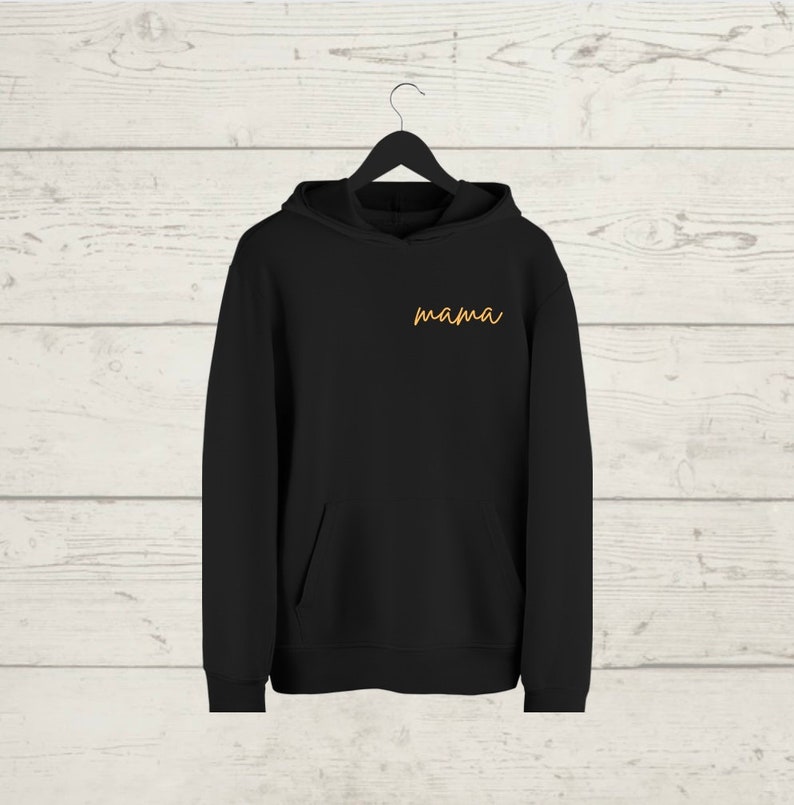 May include: Black hooded sweatshirt with a pocket and the word "mama" embroidered in orange on the front.