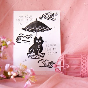 Que votre café entre en jeu, imprimé lino avec chat et parapluie