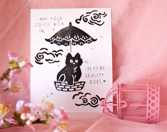 May your coffee kick in, linocut print with cat and umbrella