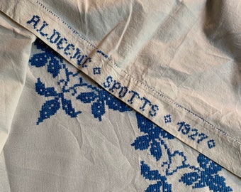 Vintage tablecloth with blue cross stitch flower basket design