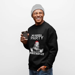 May include: A black sweatshirt with a white graphic of Jesus wearing a Santa hat and the text "We gonna party like it's my birthday".