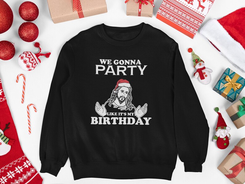May include: Black sweatshirt with a white graphic of a man wearing a Santa hat and a beard. The text on the graphic reads "We gonna party like it's my birthday".