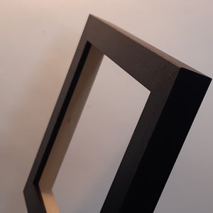 Tile frame six inch wooden and black in colour