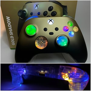 May include: A gold and black Xbox controller with colorful LED lights on the buttons. The controller is labeled "GOLD SHADOW".