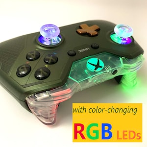 Könnte beinhalten: Ein grüner Xbox-Controller mit transparenten Kunststoffakzenten und farbwechselnden RGB-LEDs. Der Controller hat ein grünes Xbox-Logo und einen transparenten Kunststoffknopf mit grünem Licht.