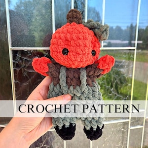 May include: Crochet pattern for a pumpkin-shaped amigurumi doll with a green and brown striped outfit. The doll has a red pumpkin head with black eyes and a small brown stem.