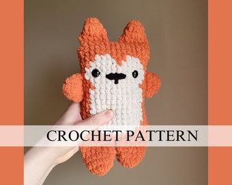 May include: Crochet pattern for a plush orange and white fox toy. The fox has black eyes and a black nose.