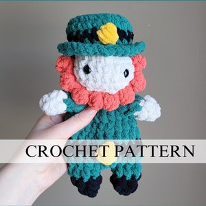 May include: Crochet pattern for a green leprechaun doll with a black hat and a yellow shamrock. The doll has a white face, red beard, and black shoes.
