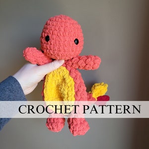 Op de afbeelding: Haakpatroon voor een rood en geel dinosaurus knuffel. Het speelgoed heeft zwarte ogen en een kleine staart.