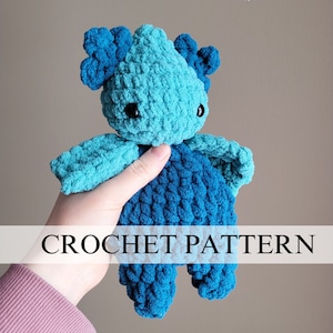 May include: A crocheted blue and teal plush toy in the shape of a creature with large ears. The toy is being held in a hand. CROCHET PATTERN is written in white text on a blue background.