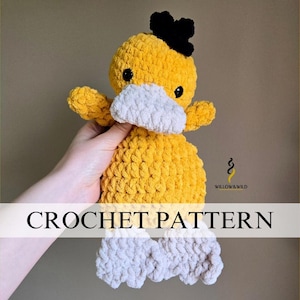 May include: Crochet pattern for a yellow duck wearing a white face mask with a black bow on top of its head. The duck has white feet.