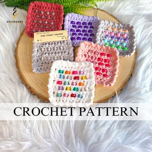 May include: A collection of six square crochet fidget squares in red, purple, grey, pink, and white, each featuring rows of colorful plastic beads. A small tan tag labeled MINI FIDGET SQUARE is attached to the grey square, and the logo WILLOW & WILD is visible.