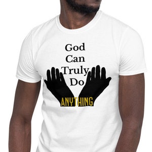 May include: White t-shirt with black text that reads "God Can Truly Do ANYTHING" with two black hands in a praying position around the word "ANYTHING".