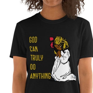 May include: Black t-shirt with a gold graphic of a girl praying with the text "GOD CAN TRULY DO ANYTHING" on it.