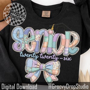 May include: Black sweatshirt with a colorful patchwork design spelling "SENIOR twenty twenty-six". The word "SENIOR" is in large, pastel-colored letters with a graduation cap. A patchwork bow is below the text. The GroovyDropStudio logo is in the upper left corner.