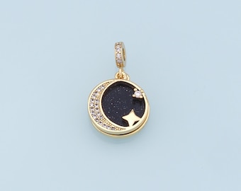 May include: Gold charm with a black crescent moon and a star, both encrusted with clear rhinestones.