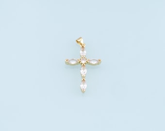 May include: A gold cross pendant with clear crystal accents.