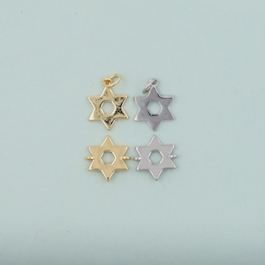 May include: Four Star of David charms, two gold and two silver, with a hexagonal hole in the center of each star.