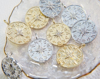 May include: A collection of eight gold and silver circular pendants with a star design and a diamond-like stone in the center. Each pendant has a different design around the star.
