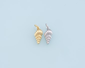 May include: Two seashell charms, one gold and one silver, on a light blue background.