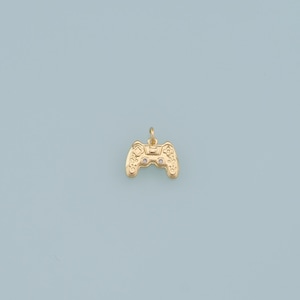 May include: A gold-colored video game controller charm with small clear stones for buttons.