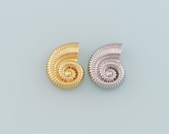 May include: Two nautilus shell shaped earrings, one gold and one silver.