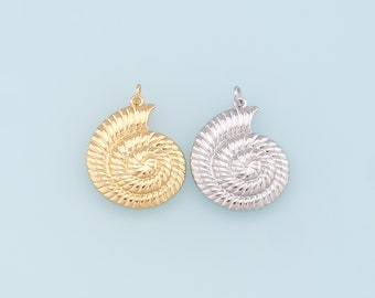 May include: Two gold and silver nautilus shell charms. The charms are detailed with a spiral pattern and have a loop at the top for attaching to a necklace or bracelet.