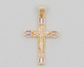 May include: Gold-tone cross pendant with clear and pink cubic zirconia stones. The cross features a detailed figure of Jesus Christ.