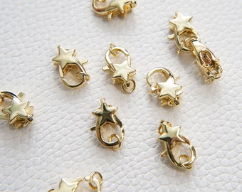 May include: Nine gold-tone star-shaped clasps for jewelry making. Each clasp features a star design with a loop for attaching to a chain or cord.