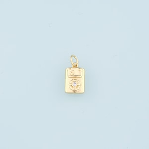 May include: Gold charm in the shape of a cassette tape with a single diamond in the center.