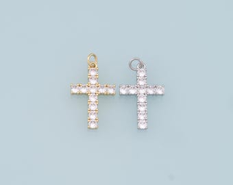 May include: Two silver and gold cross pendants with clear crystal embellishments. The crosses are both the same size and shape.