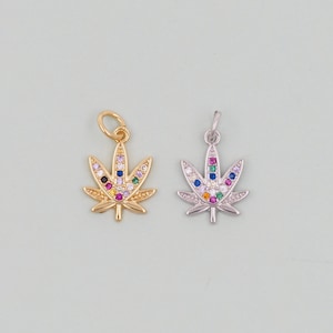 May include: Two gold and silver marijuana leaf charms with colorful rhinestones. The charms are perfect for adding a touch of whimsy to jewelry or crafts.