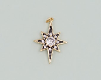 May include: Gold-tone star charm with a clear rhinestone center and black accents. The star has eight points and is a popular charm for jewelry making.