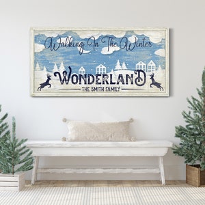 May include: A blue and white sign with the text "Walking in the Winter Wonderland - The Smith Family". The sign features a winter scene with snow-covered houses, trees, and reindeer.