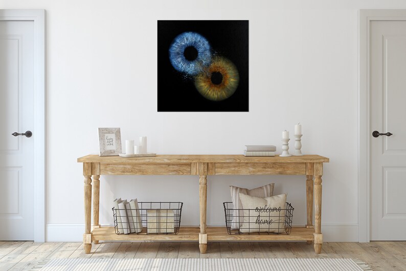 May include: Two close-up images of human irises, one blue and one brown, on a black background.