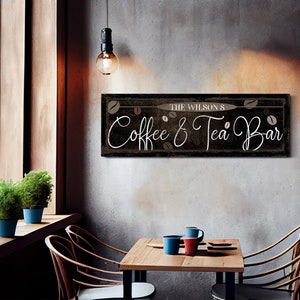 May include: A rustic wooden sign with the text "The Wilson's Coffee & Tea Bar" in white script. The sign is decorated with brown coffee beans and has a distressed black background.