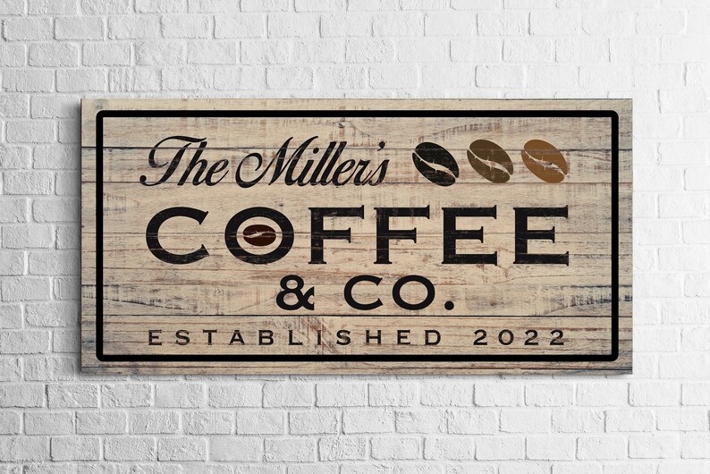 May include: A rustic wooden sign with the text "The Millers' Coffee & Co. Established 2022" in black lettering. The sign features a brown woodgrain background and three coffee bean illustrations.