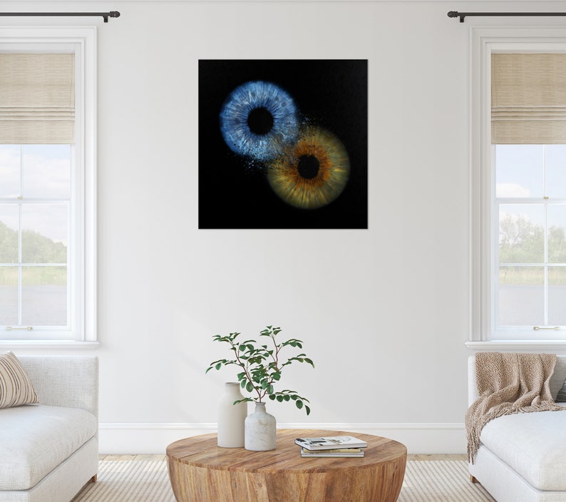 May include: Abstract art print featuring two overlapping irises, one blue and one brown, on a black background.