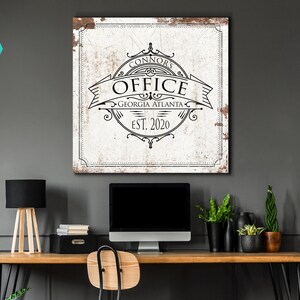 May include: A white canvas print with a distressed, vintage look. The print features a black and white design of a circular logo with the text "Connor's Office Georgia Atlanta Est. 2020".